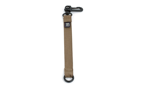 An 8-inch Coyote (tan) Key Strap with a snaphook at one end and an o-ring at the other.
